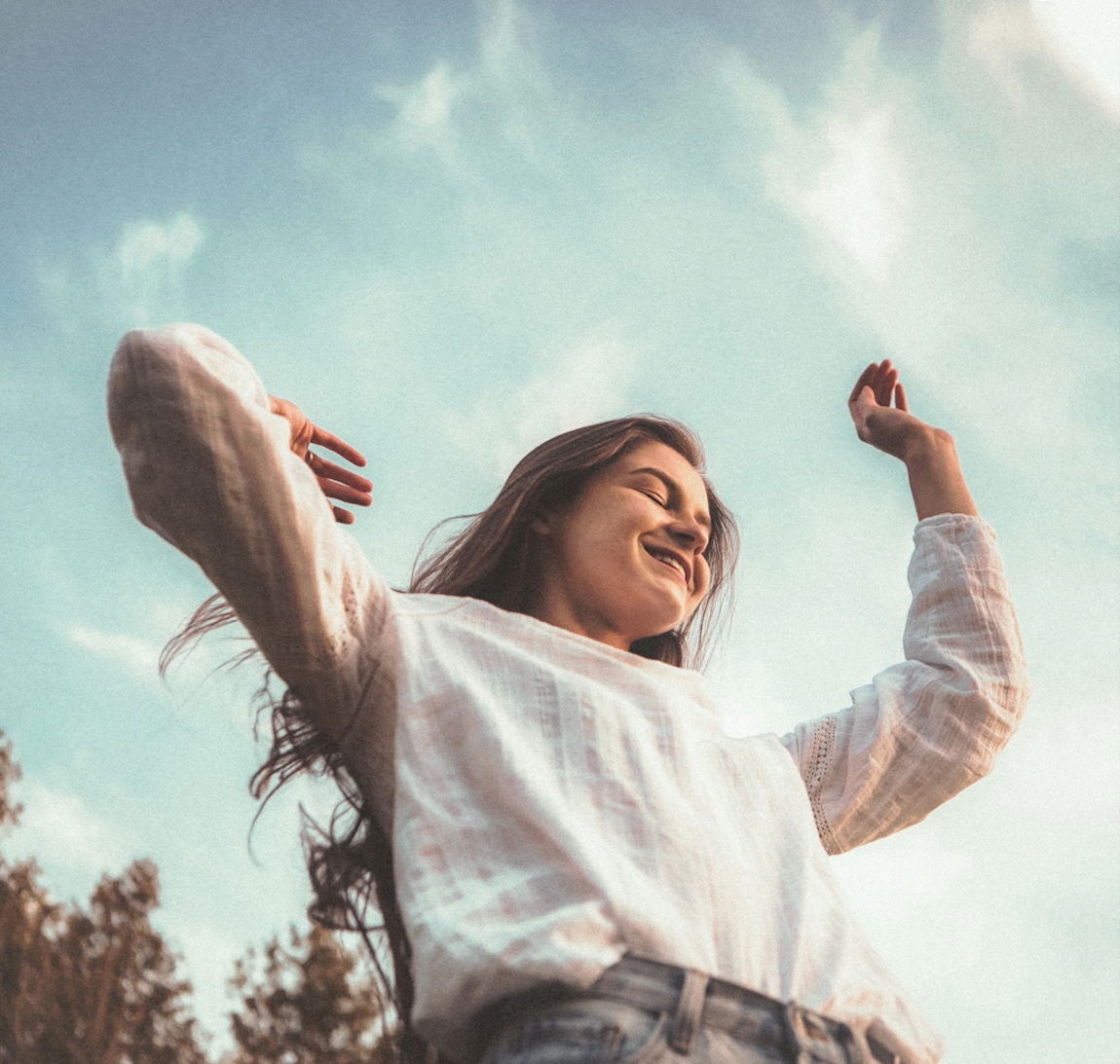 woman in white long sleeve shirt and blue denim jeans